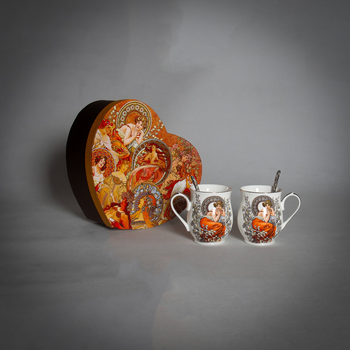 Mucha 2 White Mugs and Spoons with a decorative box on the grey background