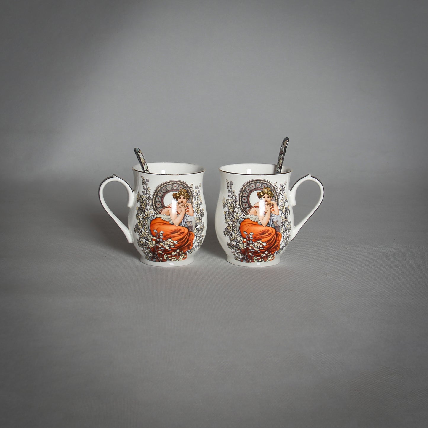 Mucha 2 White Mugs and Spoons on the grey background