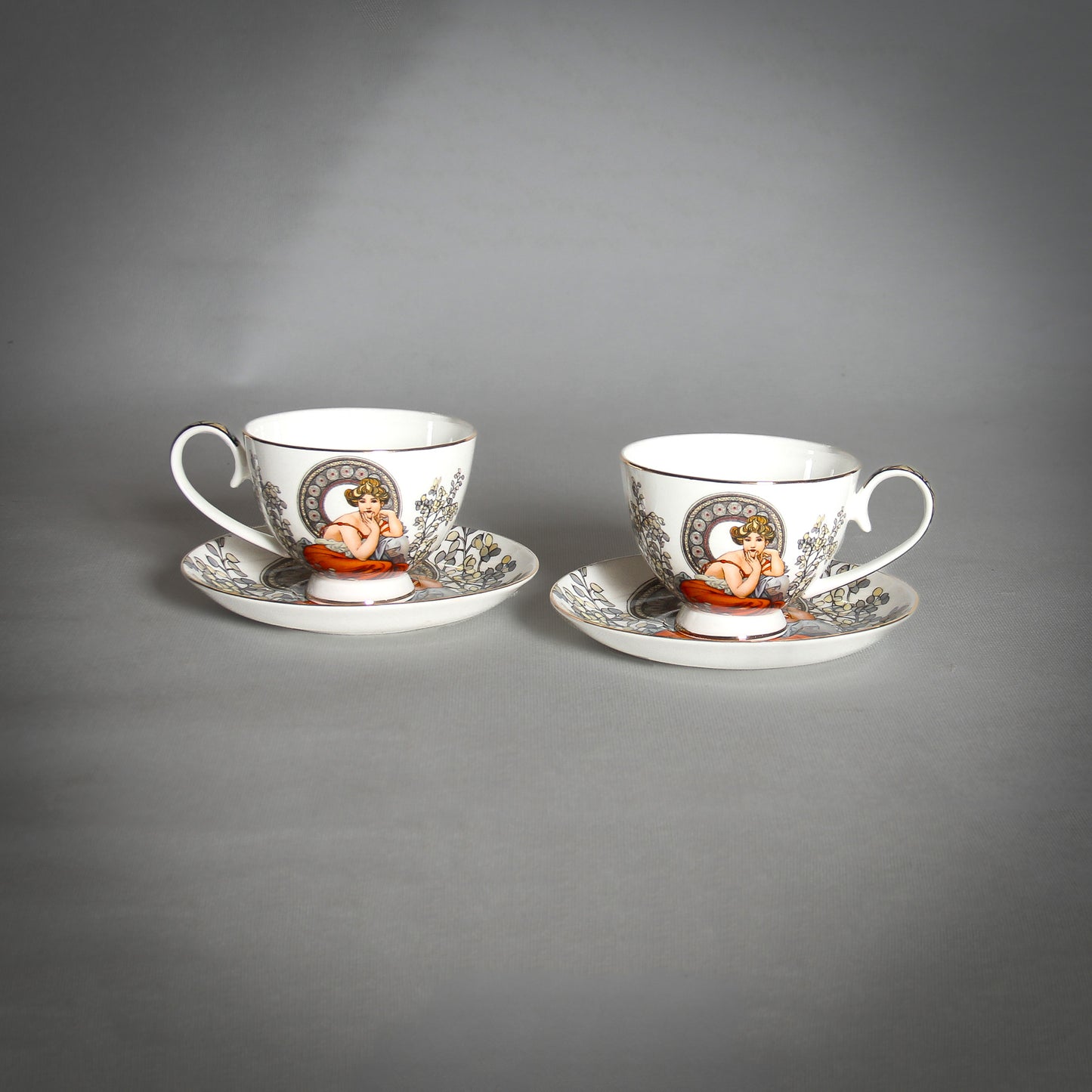 Mucha White Tea Cups and Saucers on the grey background