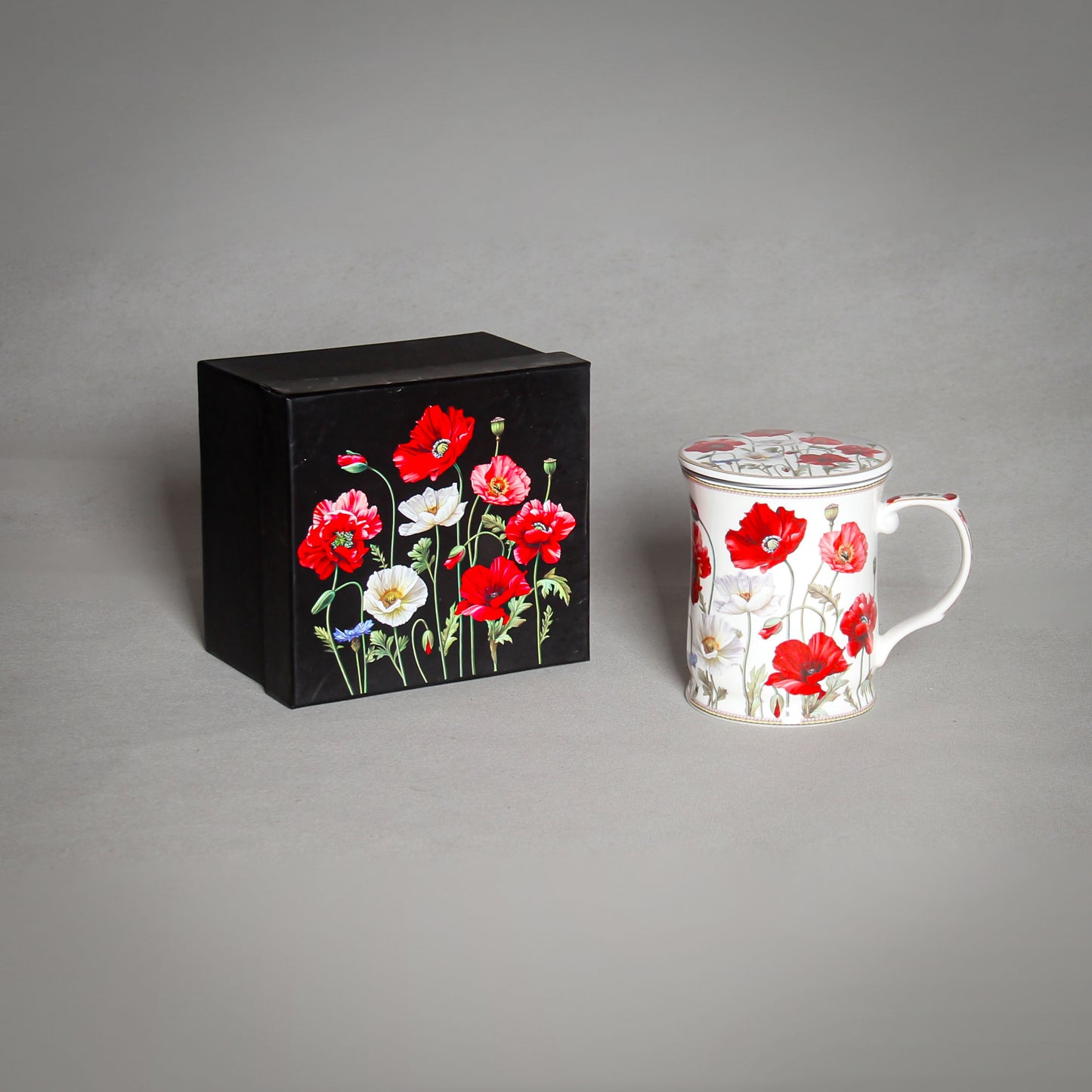 "The Poppy" Tea Infuser with a Lid and a black box with poppies on the grey background