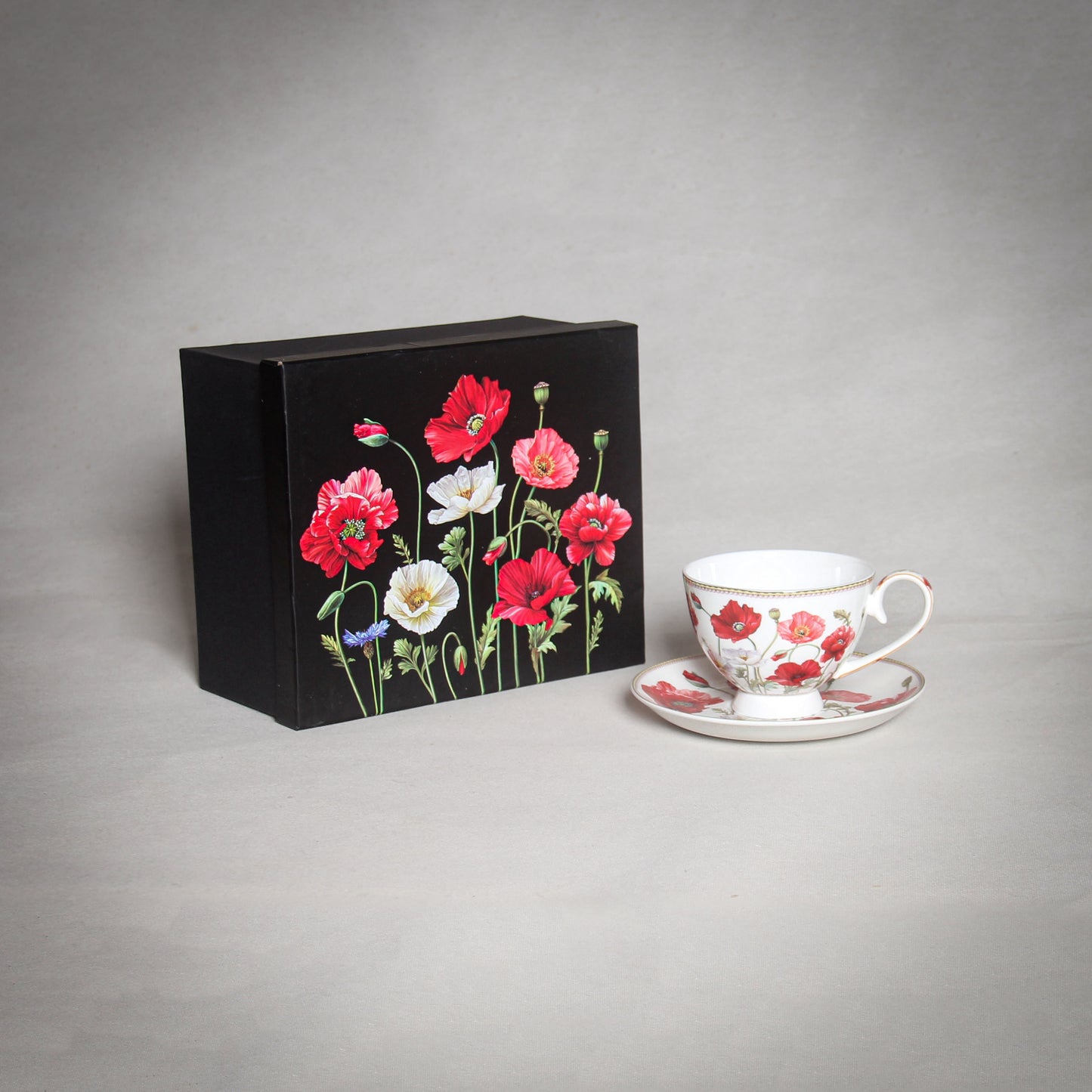 "The Poppy" White Cup and a black box with poppies on the grey background
