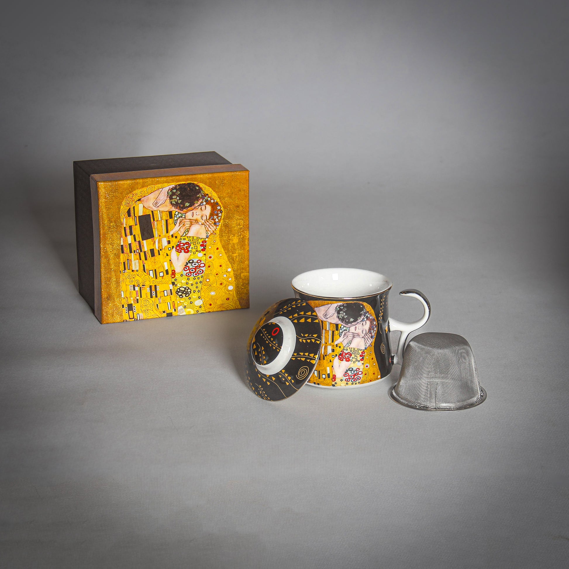 Gustav Klimt "The Kiss" Black Tea Infuser and its parts on the grey background