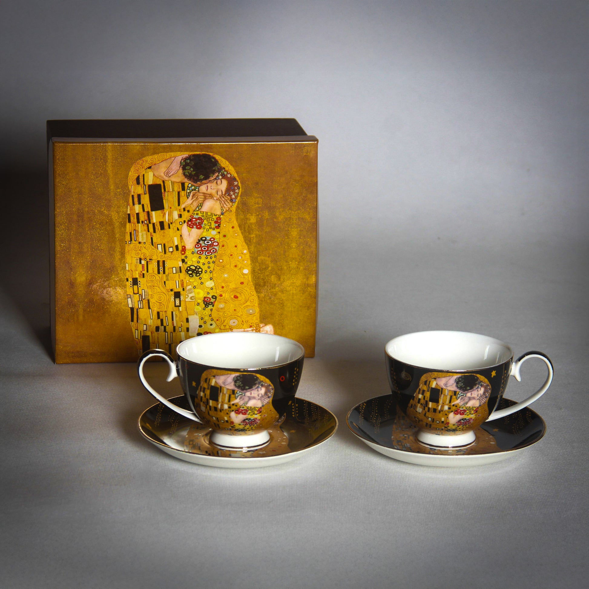 front and side view of Gustav Klimt The Kiss Cups and a matching saucer on a grey background