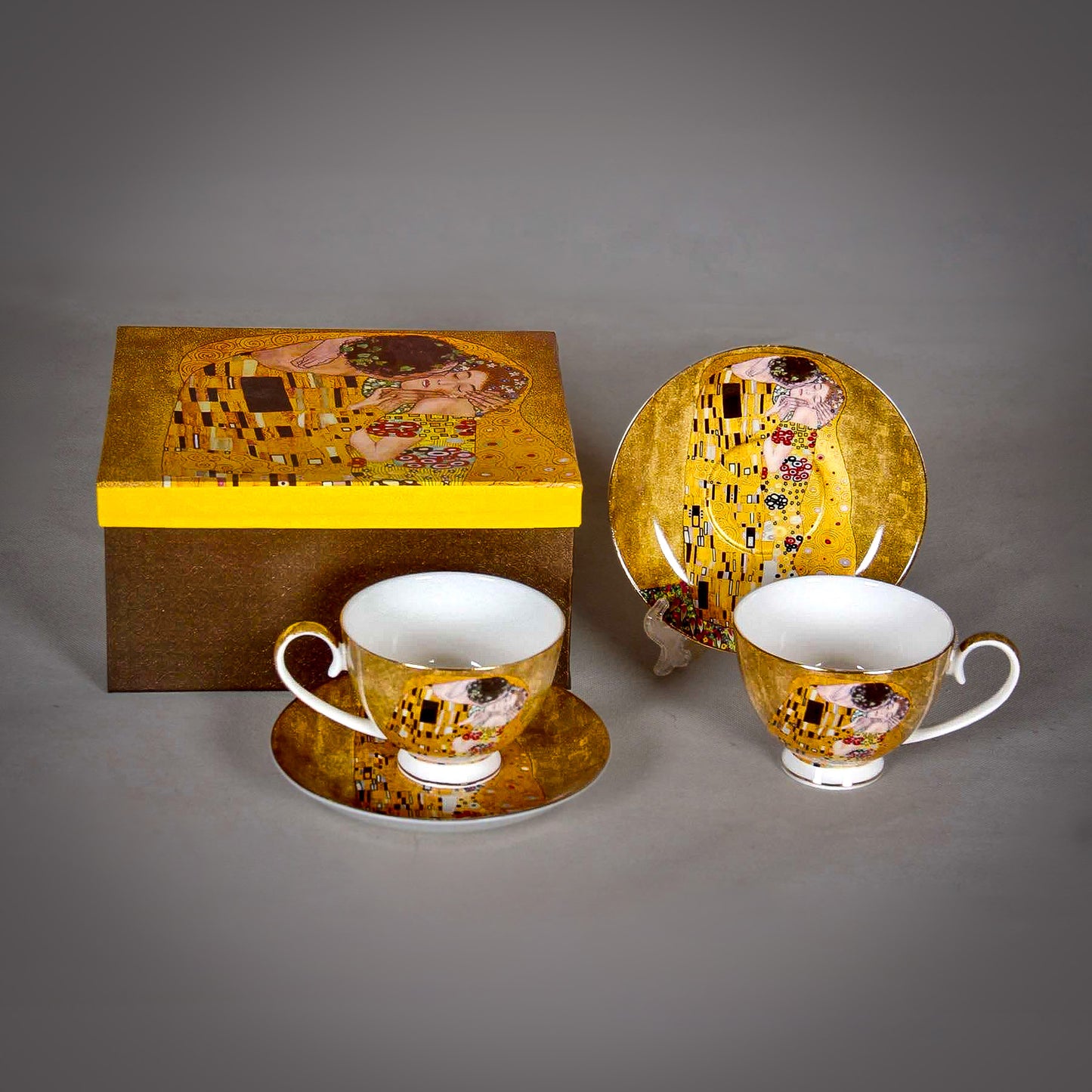 front and side view of Gustav Klimt The Kiss Cup and a matching Saucer on a grey background