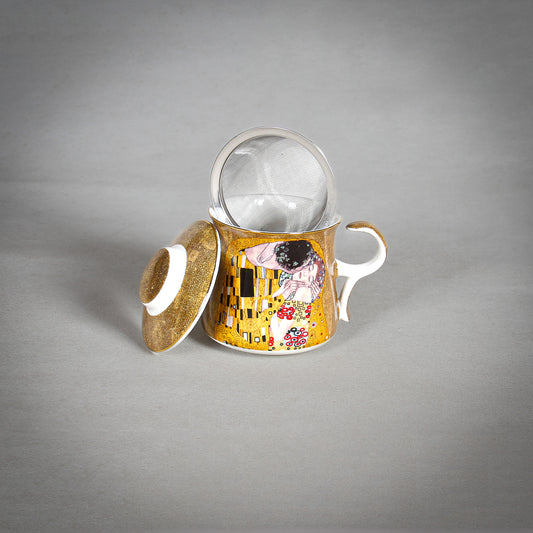 opened Gustav Klimt "The Kiss" Golden Tea Infuser o n the grey background