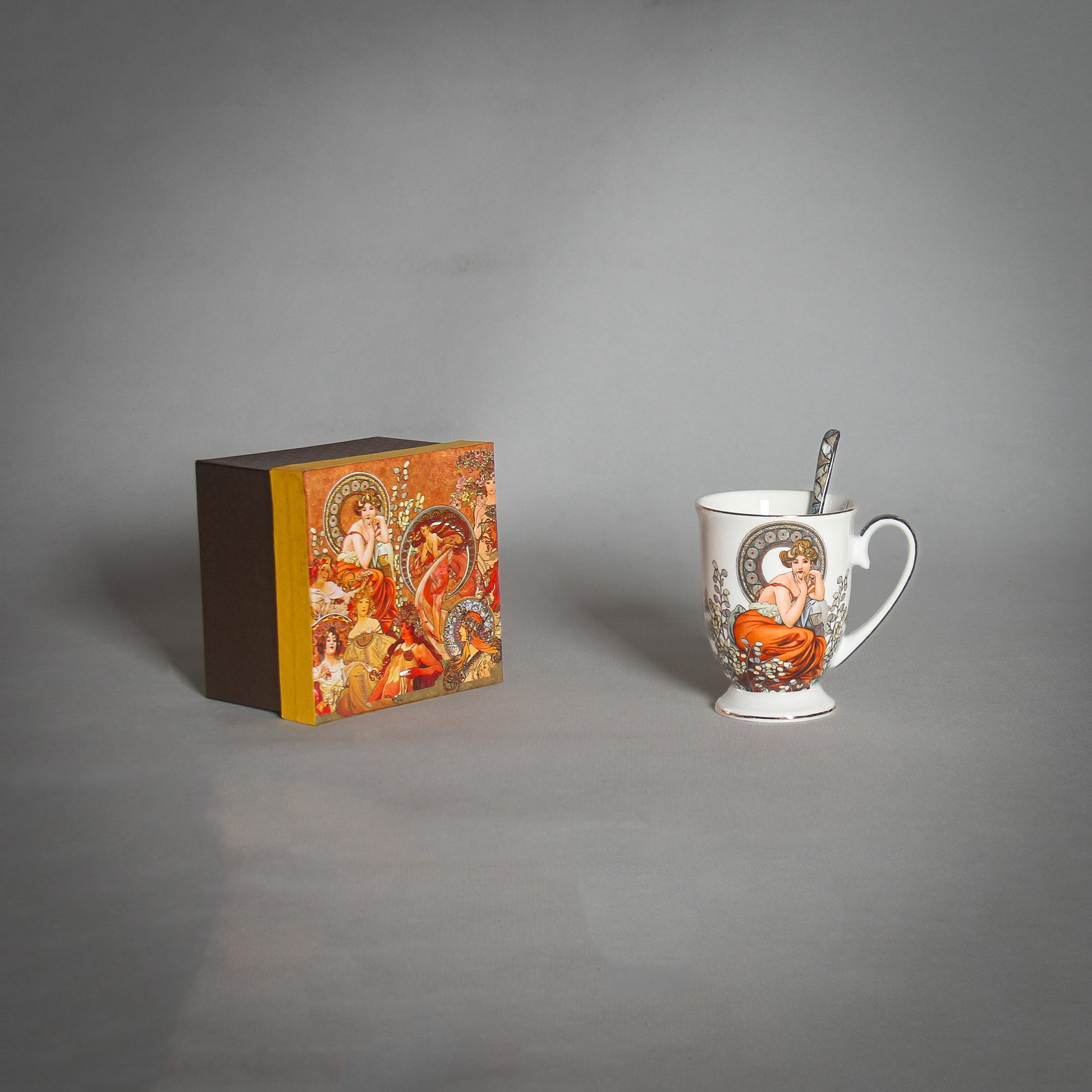 Mucha White Mug and a matching box on the grey background