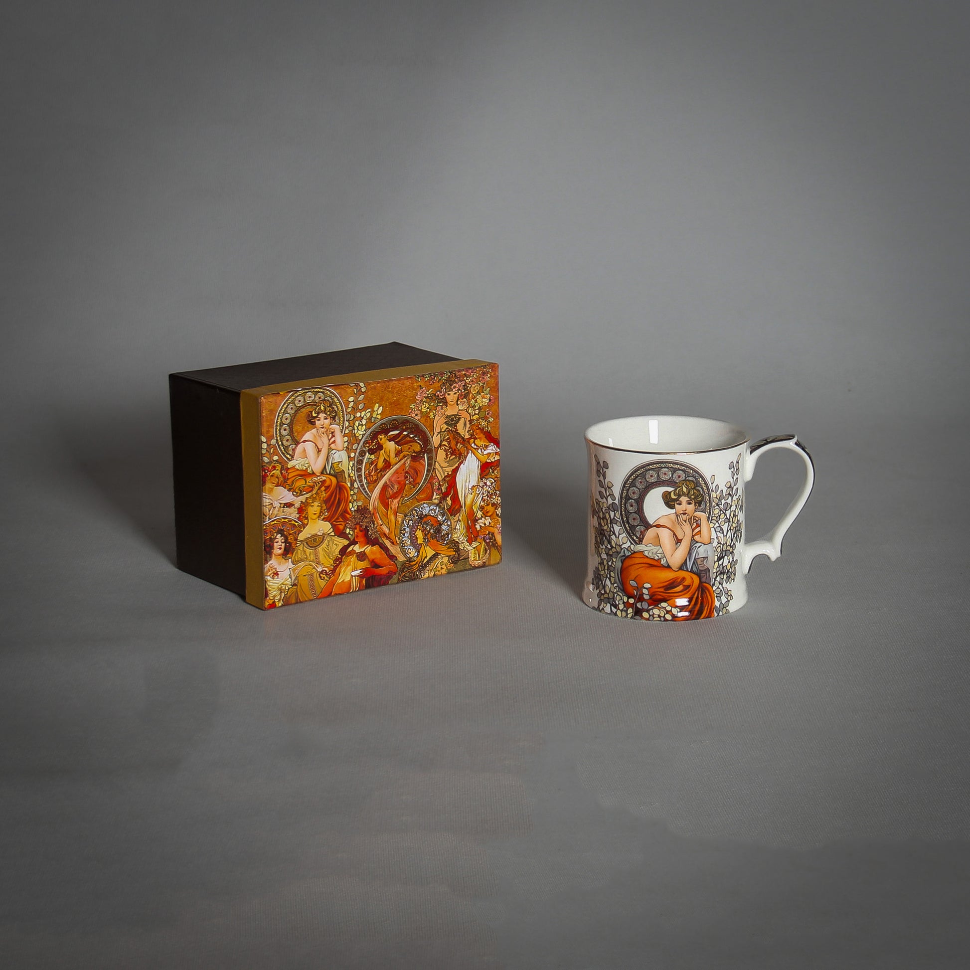 Mucha White Tea Mug and a decorative box on the grey background 