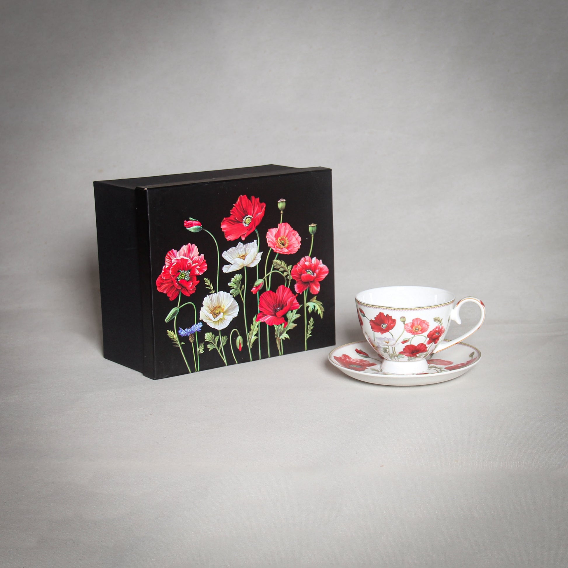"The Poppy" White Cup and a black box with poppies on the grey background